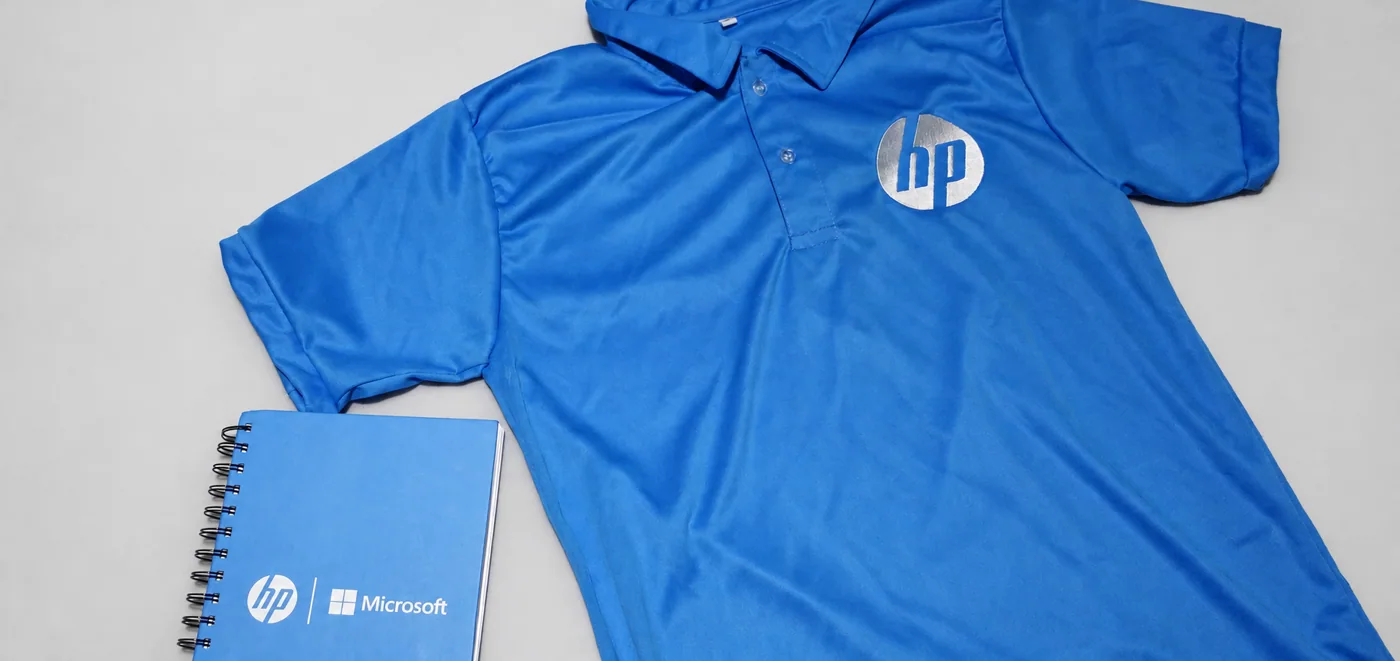 Corporate printed polo shirt and notebook produced for a campaign through Great Minds